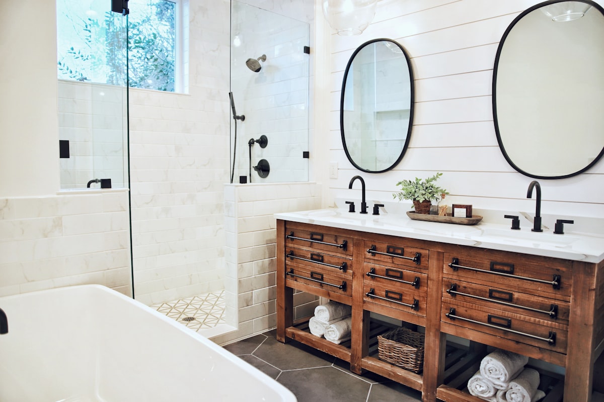 white ceramic bathtub near brown wooden cabinet related to Elevate Your Bathroom Style with a Shower Curtain and Valance