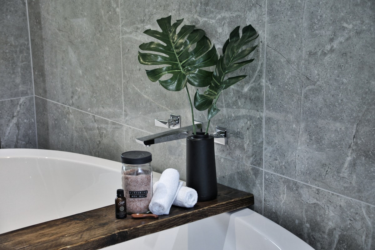 white ceramic bathtub with soap bottles related to Elevate Your Bath: The Perfect Guide to Valance Shower Curtain Sets