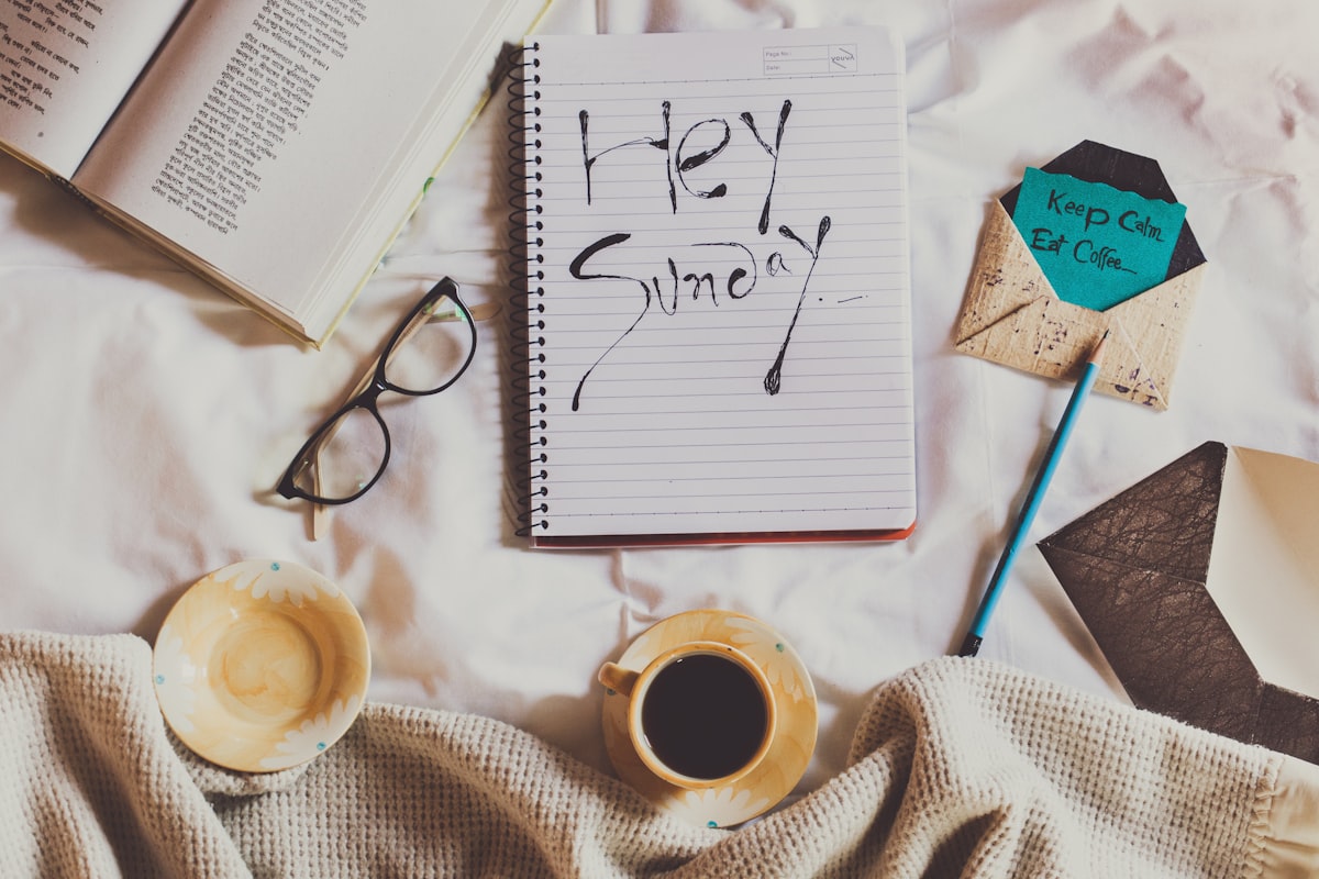 white ceramic mug on white notebook beside blue pen related to Unlocking the Secrets of the Bed-Stuy-Draco Neighborhood