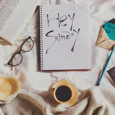 white ceramic mug on white notebook beside blue pen related to Unlocking the Secrets of the Bed-Stuy-Draco Neighborhood