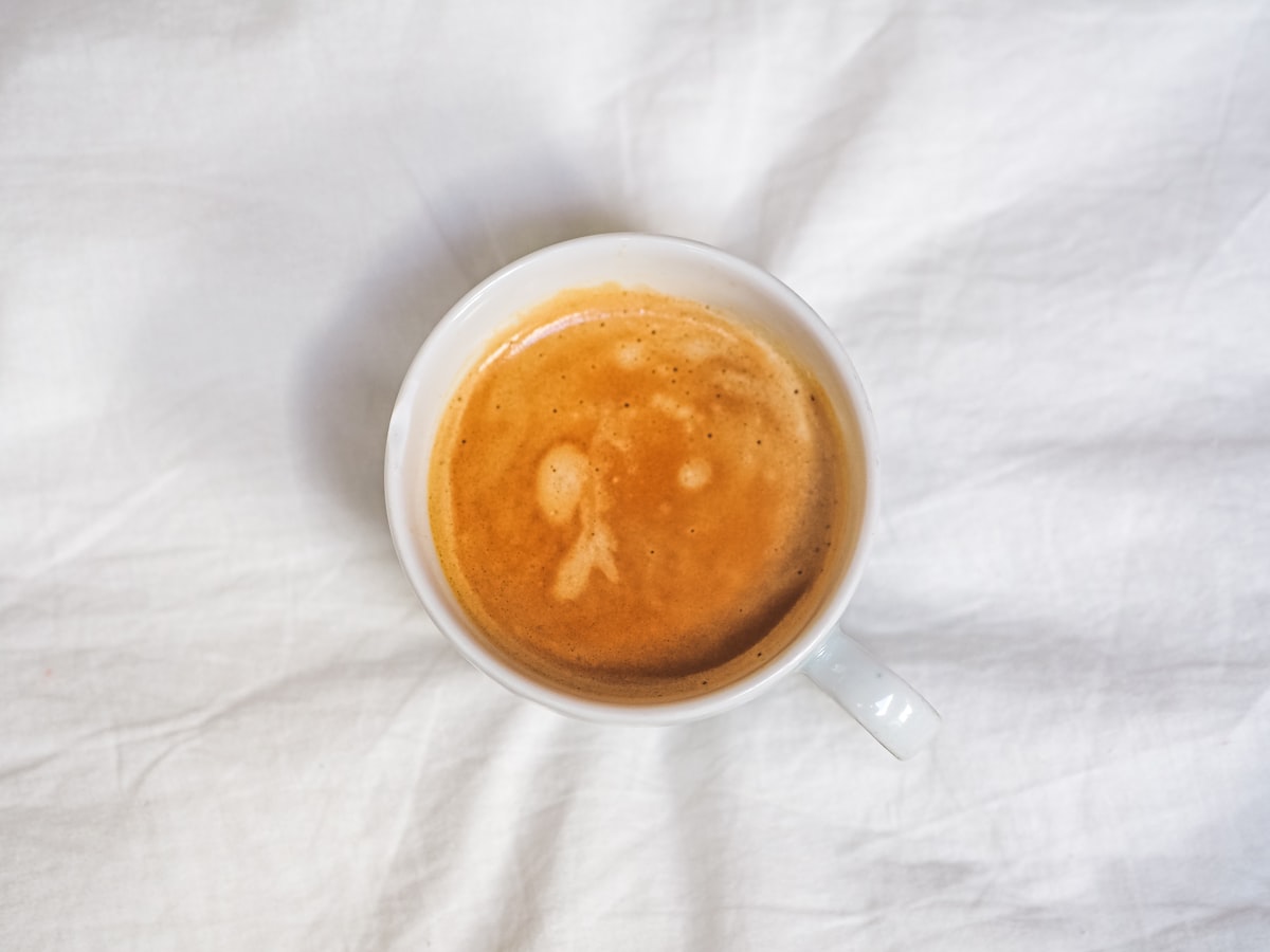 white ceramic mug with brown liquid related to The Ultimate Guide to Bed Bath and Beyond Espresso Machines