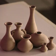 white clay vases on table related to Ceramic Clay Chiminea for Sale