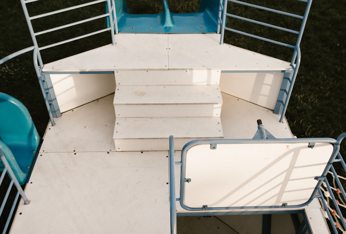 white concrete stairs with blue metal railings related to Exploring the Versatility of Loft Beds