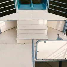 white concrete stairs with blue metal railings related to Exploring the Versatility of Loft Beds