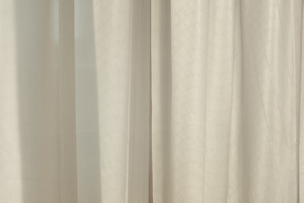 white curtain near white wall related to Add a Touch of Elegance with Sheer Swag Valances