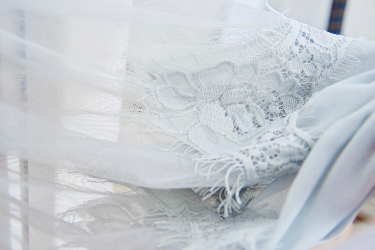 white floral textile on brown wooden table related to Sheer Scarf Valance