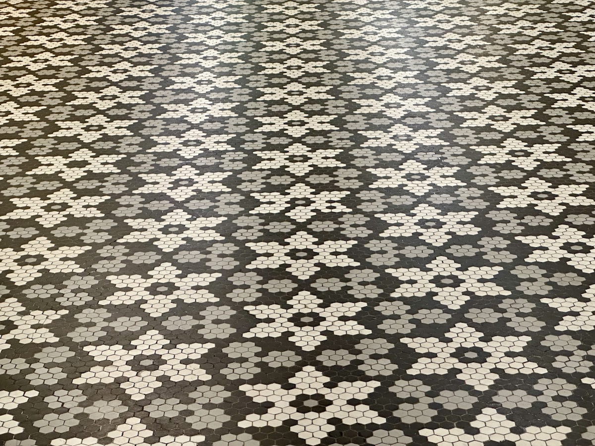 White marble honeycomb floor tiles in a flower pattern. related to Transform Your Entryway with the Perfect Floor Tile
