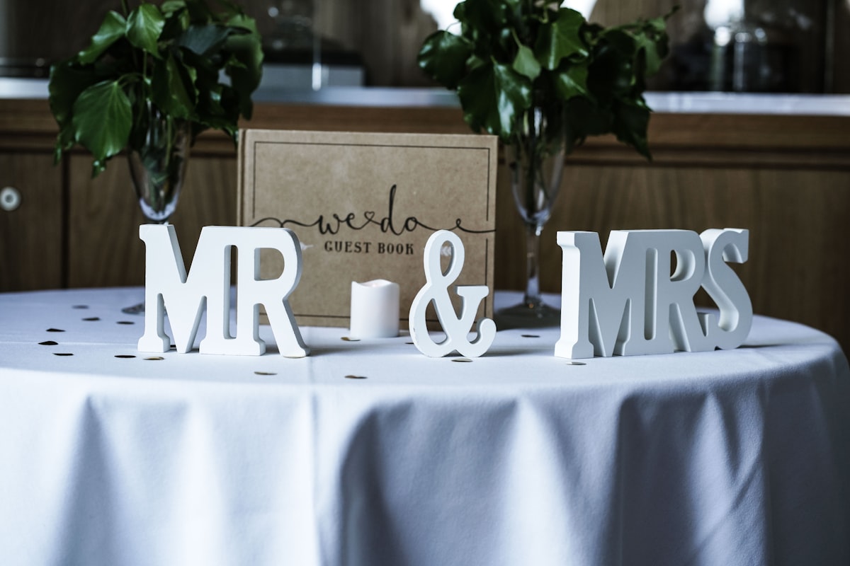 white Mr & Mrs freestanding letters on table with white spread related to Cozy Slumber: The Ultimate Guide to Mr and Mrs Bedding Sets