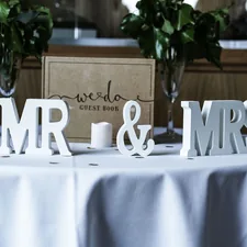 white Mr & Mrs freestanding letters on table with white spread related to Cozy Slumber: The Ultimate Guide to Mr and Mrs Bedding Sets