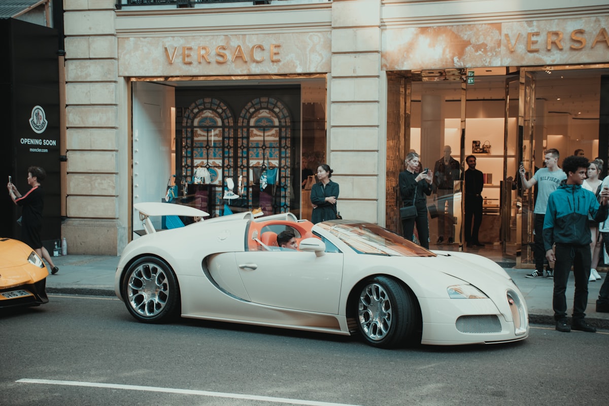white porsche 911 parked in front of building related to Sleep Like Royalty: The Ultimate Guide to Versace Bed Sets