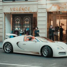 white porsche 911 parked in front of building related to Sleep Like Royalty: The Ultimate Guide to Versace Bed Sets