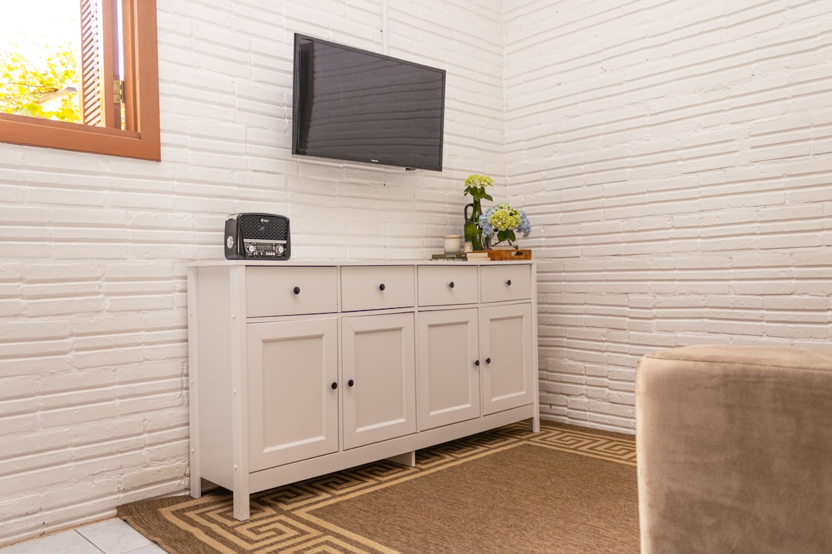 White sideboard with a television mounted above. related to Elegant Sideboard with Hutch: Enhancing Your Dining Space