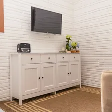 White sideboard with a television mounted above. related to Elegant Sideboard with Hutch: Enhancing Your Dining Space