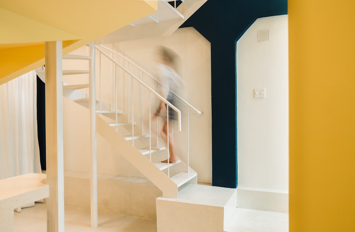 white staircase with blue wooden doors related to Elevate Your Bedroom: White Bunk Beds with Stairs for Kids