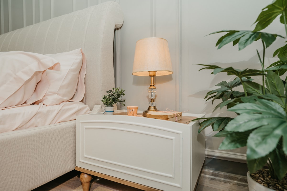 white table lamp on white wooden side table related to Elevate Your Sleep Experience with Adjustable Bed Risers