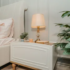 white table lamp on white wooden side table related to Elevate Your Sleep Experience with Adjustable Bed Risers