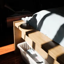 white textile on brown wooden table related to Maximizing Space: Ergonomic Twin Bed with Storage Options