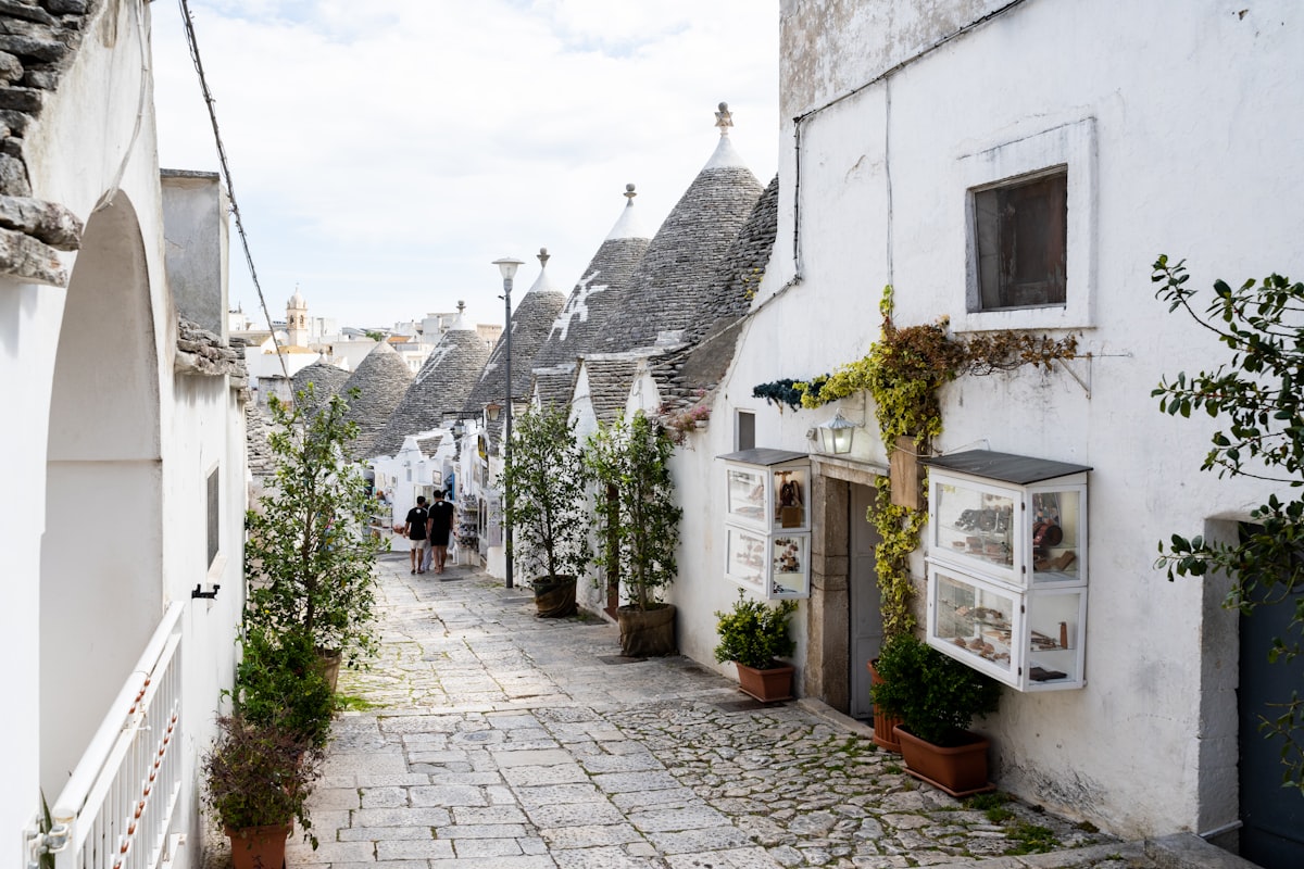 White trulli houses and shops line a narrow street. related to Discover the Charm of the Raleigh Bed