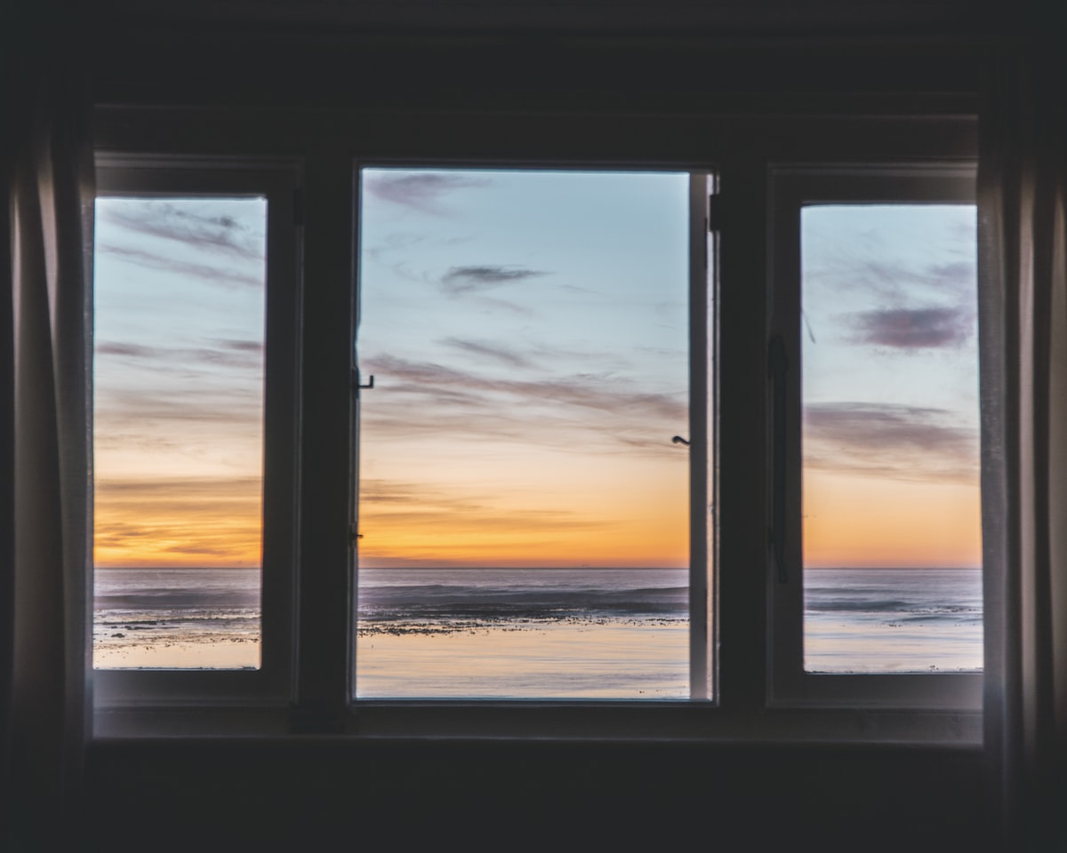 white wooden framed glass window near body of water related to Elevate Your Windows with Beautiful Curtains with Valance