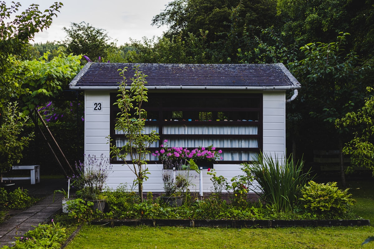 white wooden house near green grass field during daytime related to A Charming Escape: Garden House Bed & Breakfast in Key West, FL
