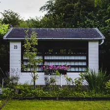 white wooden house near green grass field during daytime related to A Charming Escape: Garden House Bed & Breakfast in Key West, FL