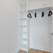 white wooden shelf with black and white shoes related to Revamping Your Entryway with a Smart Entryway Coat Closet