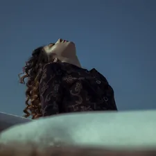 woman in black and brown floral hijab related to The Perfection of Bed Head Foxy Curls