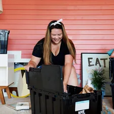 woman in black tank top sitting on black plastic crate related to Exploring the Best Big Lots Furniture Beds for Every Style and Budget