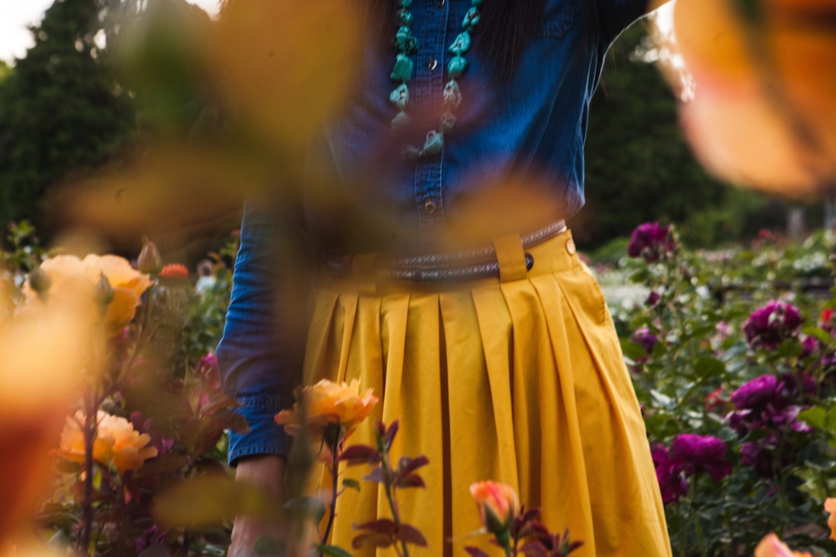 Woman in flower garden. related to Pleated Valances: Elevate Your Window Treatments