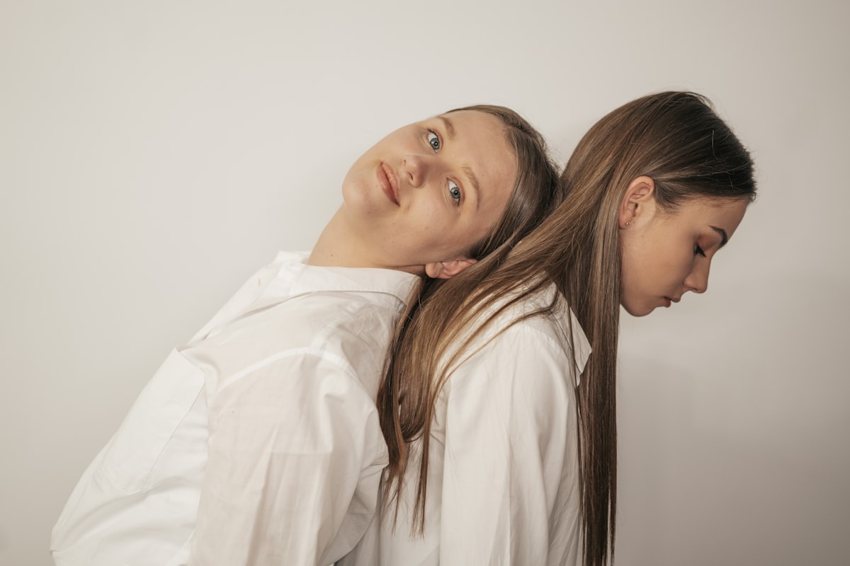 woman in white long sleeve shirt beside woman in white shirt related to The Ultimate Guide to Twin Bed Dimensions