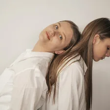 woman in white long sleeve shirt beside woman in white shirt related to The Ultimate Guide to Twin Bed Dimensions