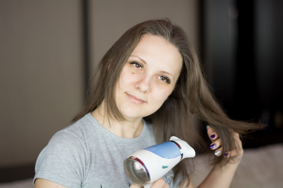 Woman looking at the camera and while drying her hair with hair dryer. More of my photos and videos Adobe Stock:http://bit.ly/3RqlciK More of my photos and videos Shutterstock: https://www.shutterstock.com/g/ALEKSANDRBERDYUGIN My email: bermix999@gmail.com related to Ultimate Guide to Bed Head Hair Stick