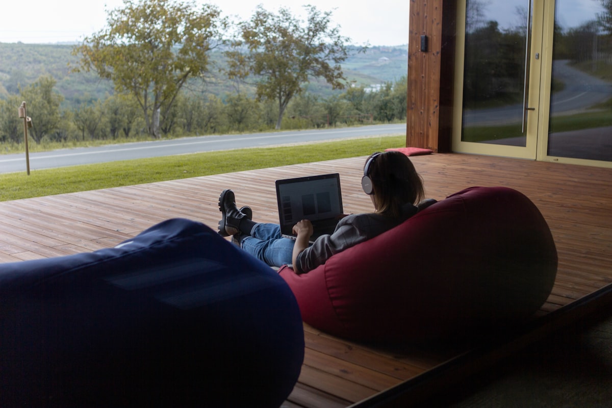 Woman remote work outdoors related to The Ultimate Guide to Bean Bag Beds