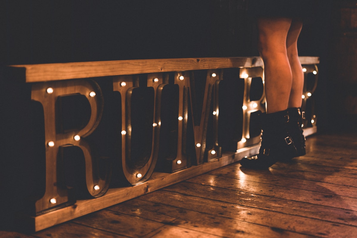 woman standing in front of brown rumble marquee sign on floor related to Define a Rustic Atmosphere
