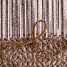 Wool string loom at a pioneer village showing 1800's era techniques for making fabric and rugs. related to Reproduction Woven Coverlets