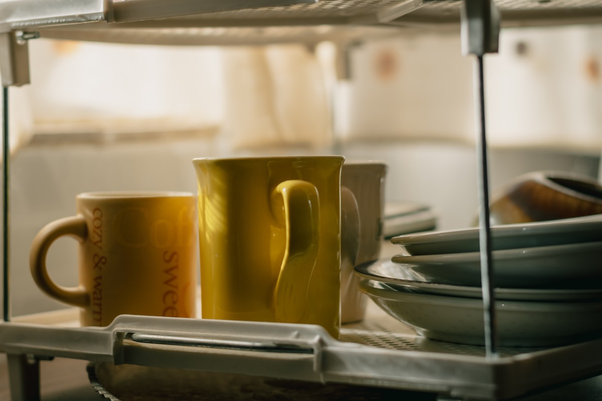 Yellow cups inside a kitchen on a sunny afternoon in autumn related to Brighten Up Your Kitchen with Yellow Valances