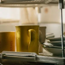 Yellow cups inside a kitchen on a sunny afternoon in autumn related to Brighten Up Your Kitchen with Yellow Valances