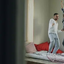 Young beautiful and loving couple dancing rocknroll dance on bed in morning at home related to Effective Exercises You Can Do Right in Bed
