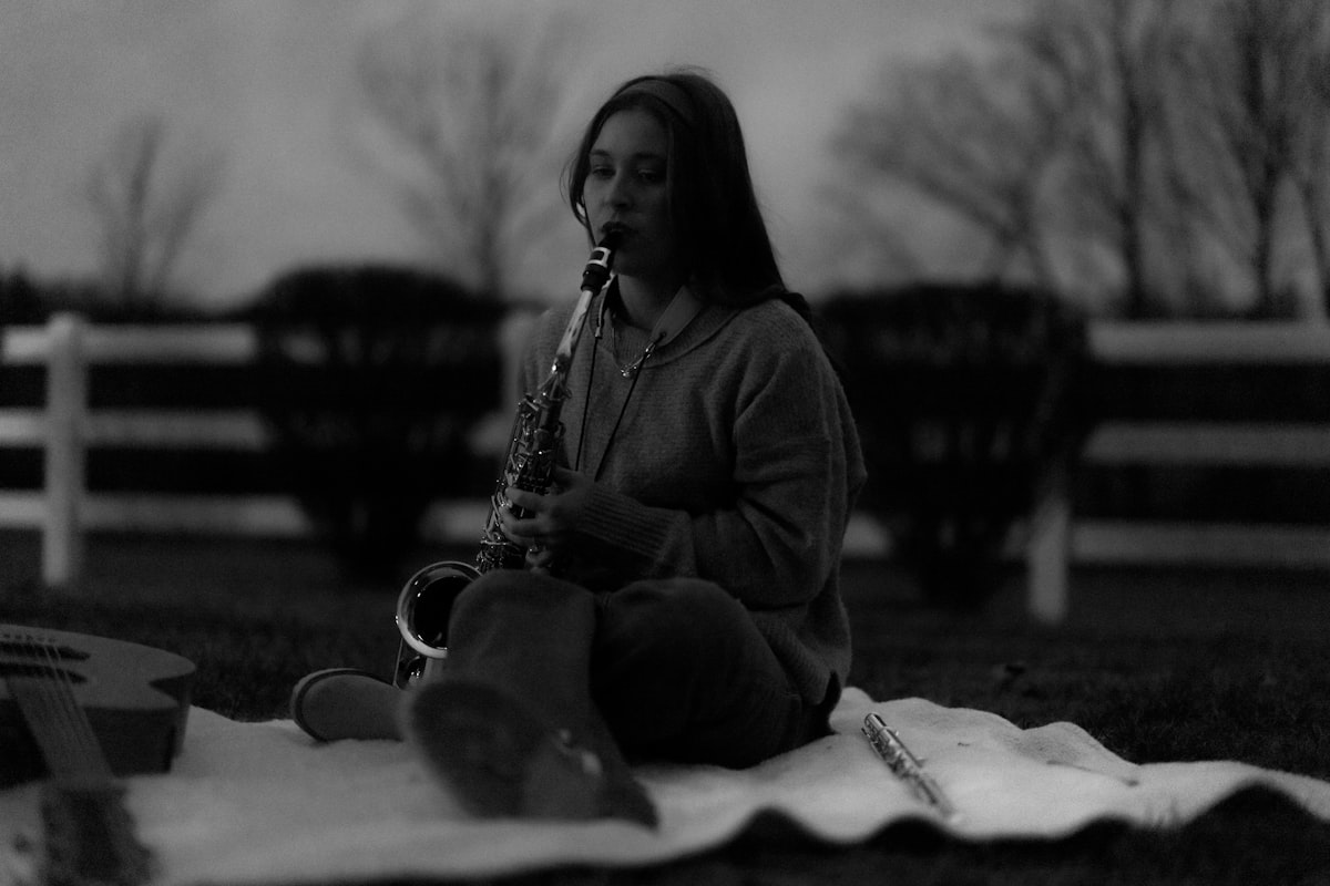 Young woman playing saxophone outdoors at dusk related to Transform Your Bedroom with Musical Themes